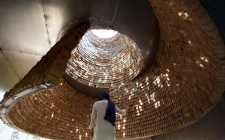 The Pause is a metal cube holding suspended bricks