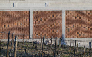 A semi-transparent brick façade made with augmented bricklaying