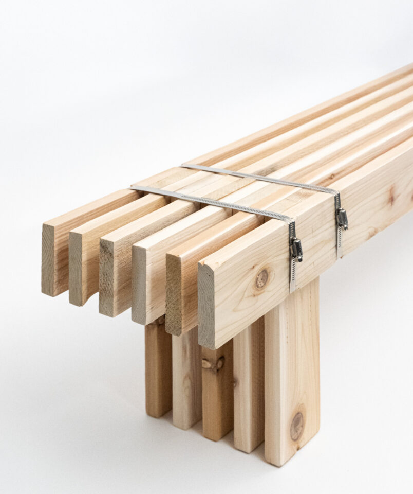Bundle of wooden slats held together by a steel strap on a white background