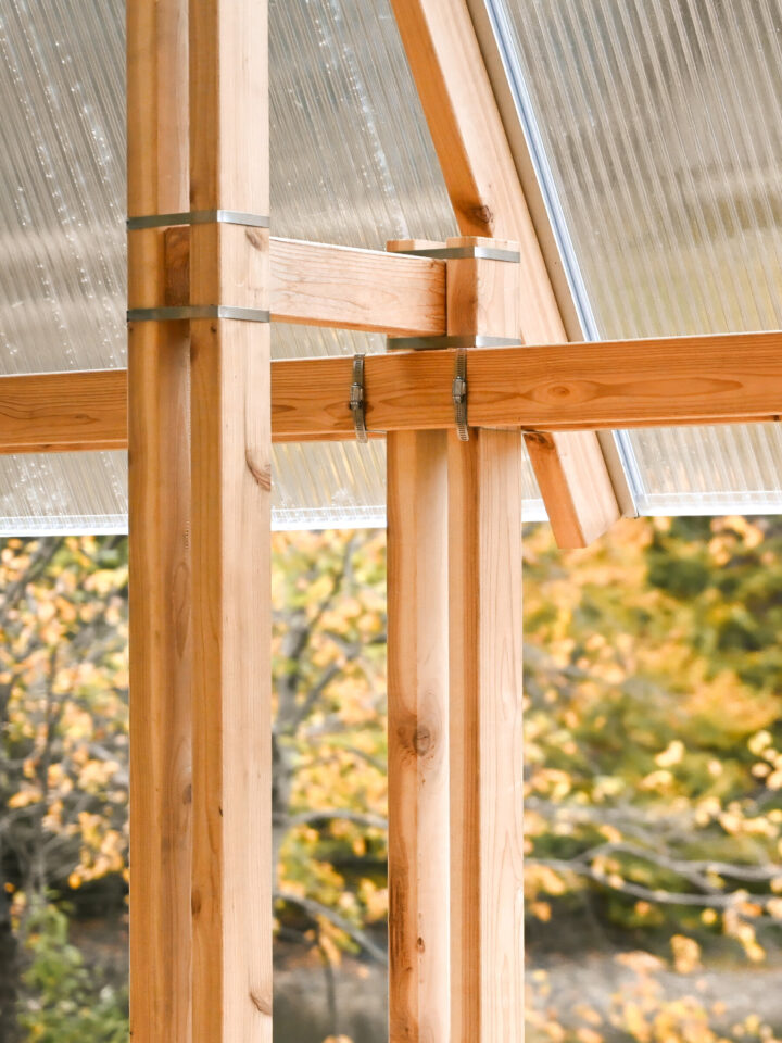Close-up of a timber post and beams joined with metal straps